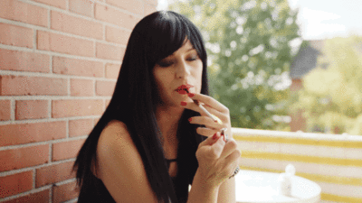 Glamorous sissy drag queen smoking erotically